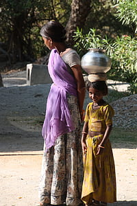 woman standing beside girl wearing sari dresses thumbnail