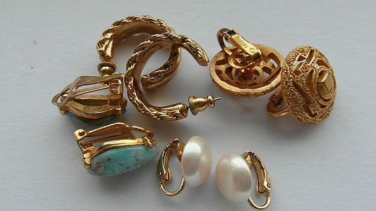 gold-colored jewelries on top of white surface thumbnail