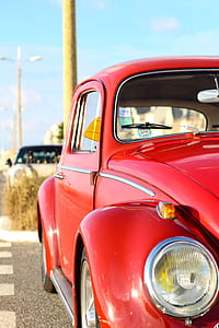 red Volkswagen Beetle coupe under blue sky at daytime thumbnail