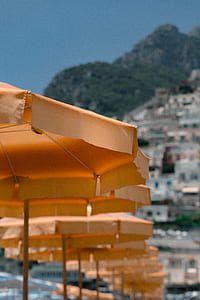 shallow focus photography of yellow patio umbrellas thumbnail