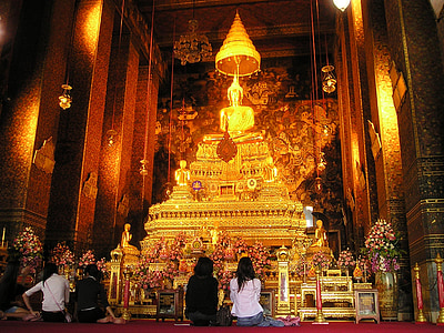 four people in front of Buddha altar thumbnail