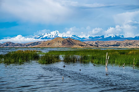 mountain under cloudy blue sky thumbnail