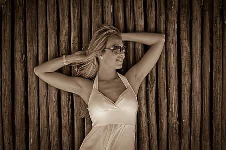 woman leaning on brown slatted surface thumbnail