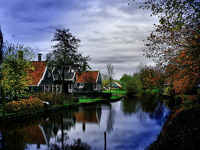 several houses near river and trees thumbnail