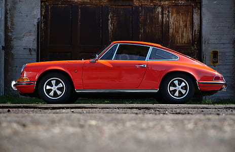 Orange Fastback Car Near Wall thumbnail