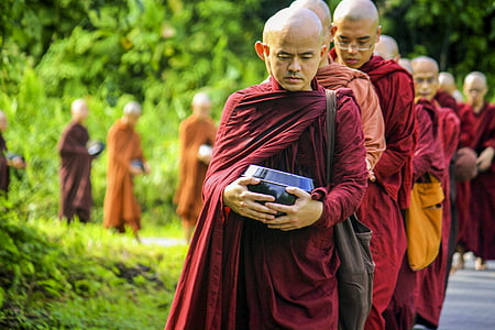 monk lining up beside the street thumbnail
