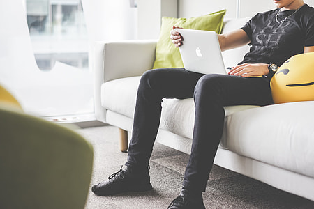 Man Working from the White Sofa in the Office thumbnail