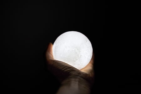 person holding white lighted ball thumbnail