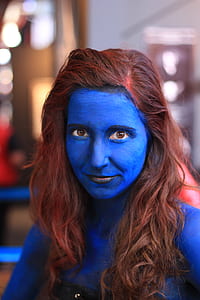 woman with blue body paint and black lipsticks in focus photography during daytime thumbnail