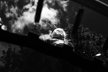 low angle view greyscale photo of a woman on roof thumbnail