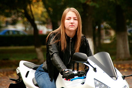 woman riding white sports bike thumbnail