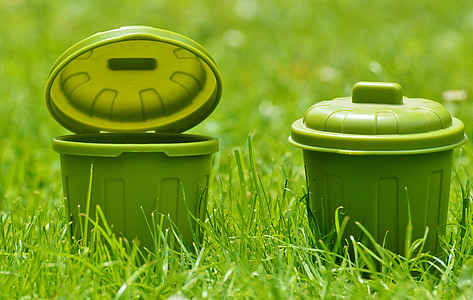 two round green plastic containers on green grass field thumbnail