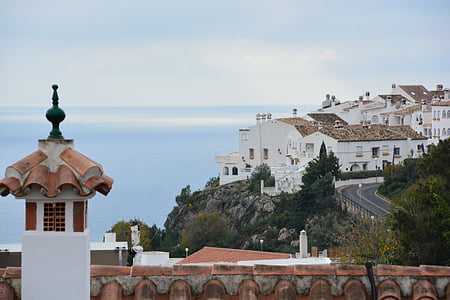 white concrete buildings overlooking body of water thumbnail