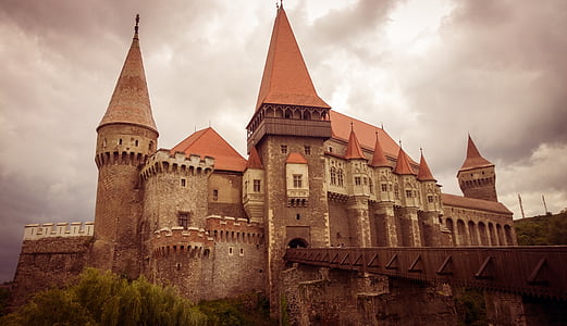 brown concrete castle under thick clouds photo thumbnail