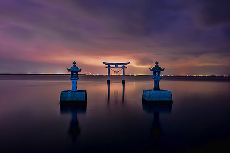 gray concrete gateway on body of water thumbnail