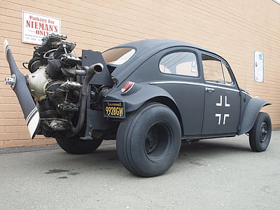 black coupe with propeller beside wall thumbnail