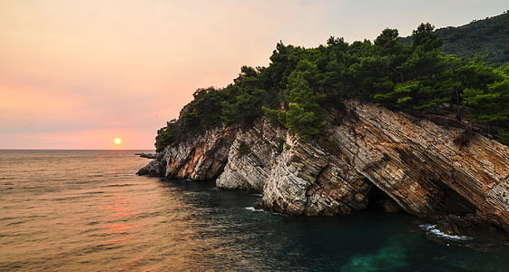 green trees on hilltop during sunset thumbnail