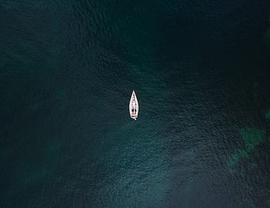 aerial photo f white boat sailing on large body of water during daytime thumbnail