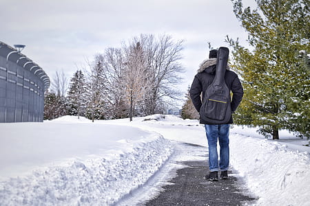 person standing on walk paht surrounded by snow thumbnail