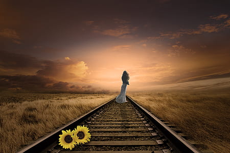 woman standing in the center of train rail thumbnail