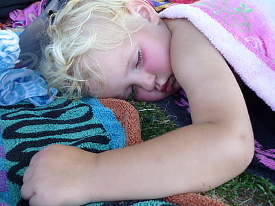baby lying on bed covering with cloth thumbnail