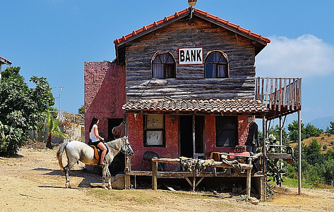 brown wooden 2-storey house with Bank signage thumbnail