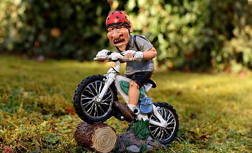 closeup photography of boy riding bicycle miniature thumbnail