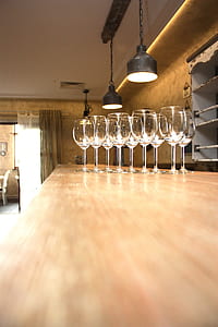 clear wineglasses on brown wooden table thumbnail