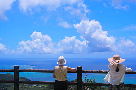 two person leaning on fence during day time thumbnail