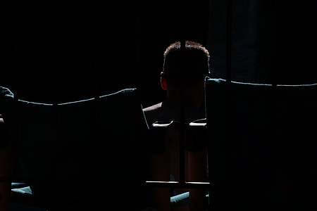 person standing in front of bars thumbnail
