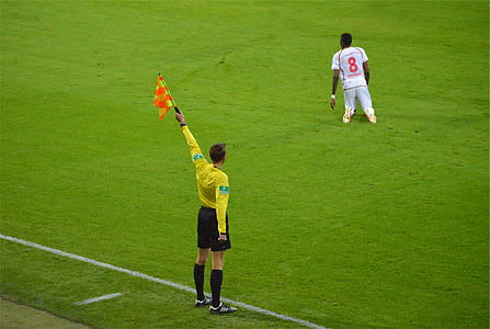 soccer umpire raising red flag thumbnail