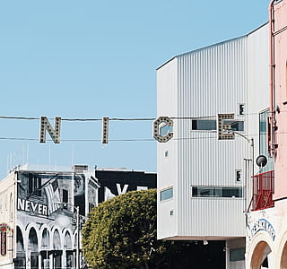 Nice signage near white building thumbnail