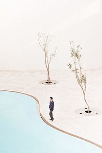 man standing beside pool and two tres painting thumbnail
