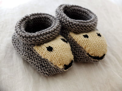 baby's grey-and-brown sheep crib shoes on white textile thumbnail