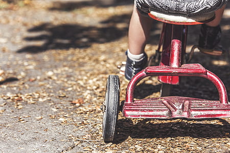 toddler sitting down on trike thumbnail