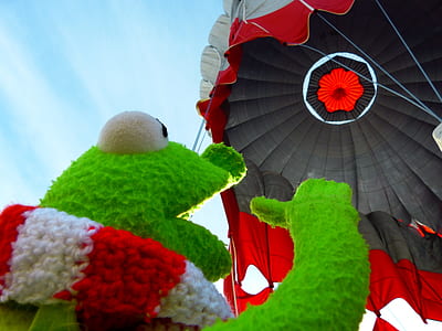 low angle photography of Kermit the frog plush toy looking upward thumbnail