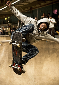 man in gray hoodie riding skateboard thumbnail