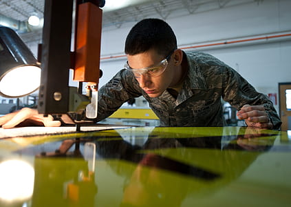 man with safety glasses cuts wood thumbnail