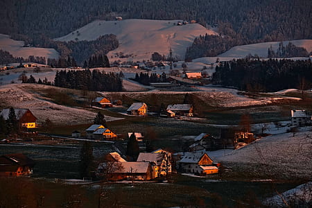 houses on snowy ground overlooking clouds at daytme thumbnail