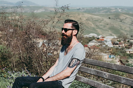 Photography of a Man Sitting on Wooden Bench thumbnail