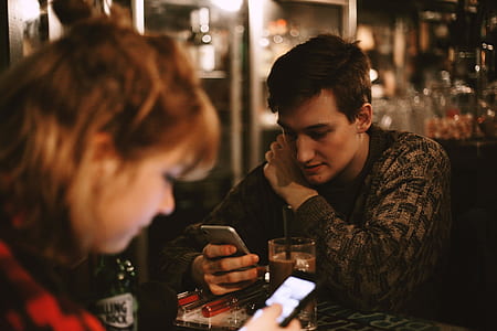 selective focus photo of man holding gray Android smartphone thumbnail