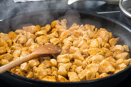 meat on black cooking pot with brown wooden ladle thumbnail
