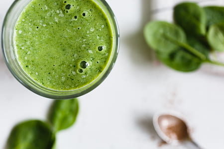spinach juice on clear glass beside gray spoon thumbnail