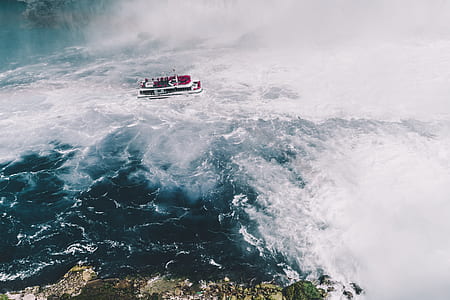 white and red boat on blue ocean water thumbnail