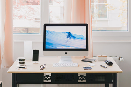 white iMac on beige and black wooden table thumbnail