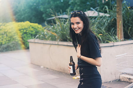 woman holding bottle and her chest thumbnail