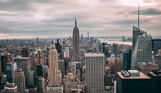 aerial photography of concrete buildings under cloudy sky thumbnail