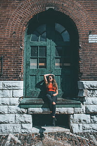 woman sitting on stair while leaning on door thumbnail