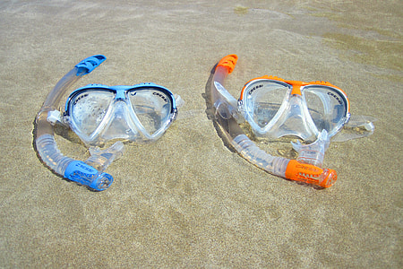 two snorkel and goggles on beach shore thumbnail