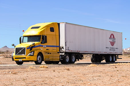white and yellow tractor unit on road thumbnail